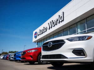 Automotive dealership forecourt with new vehicle inventory representing the need for connected DMS stock visibility across sales and CRM